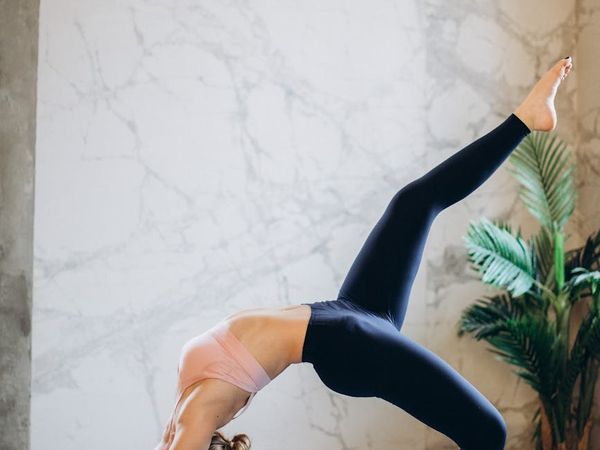 A person moving gracefully from one yoga pose to another.