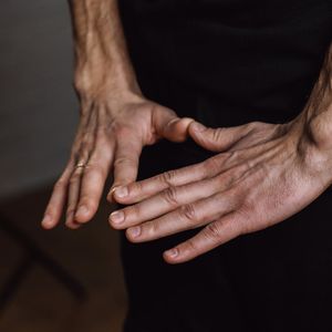 Close-up of hands in a meditative mudra position.